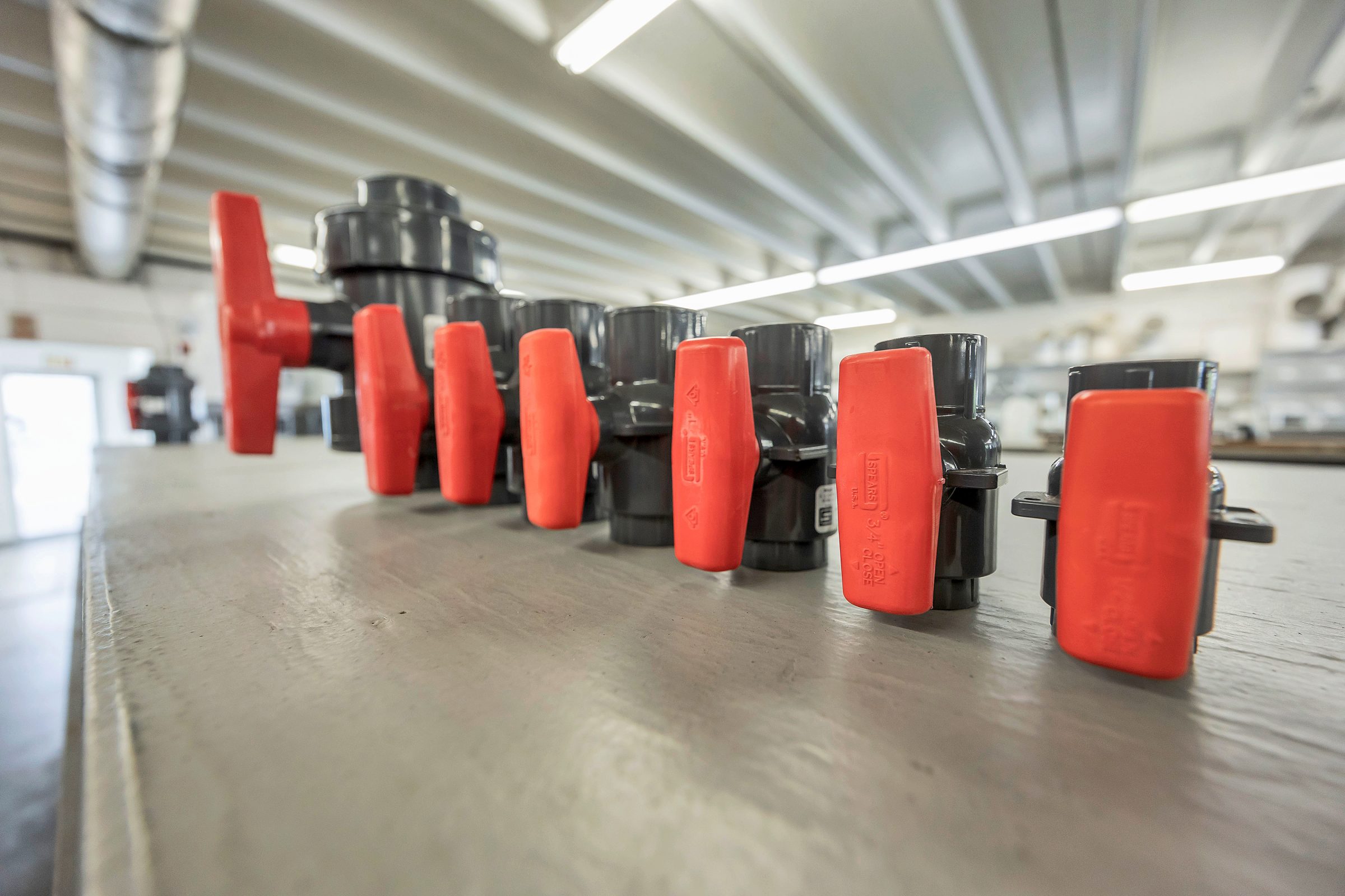 Row of industrial valves in warehouse