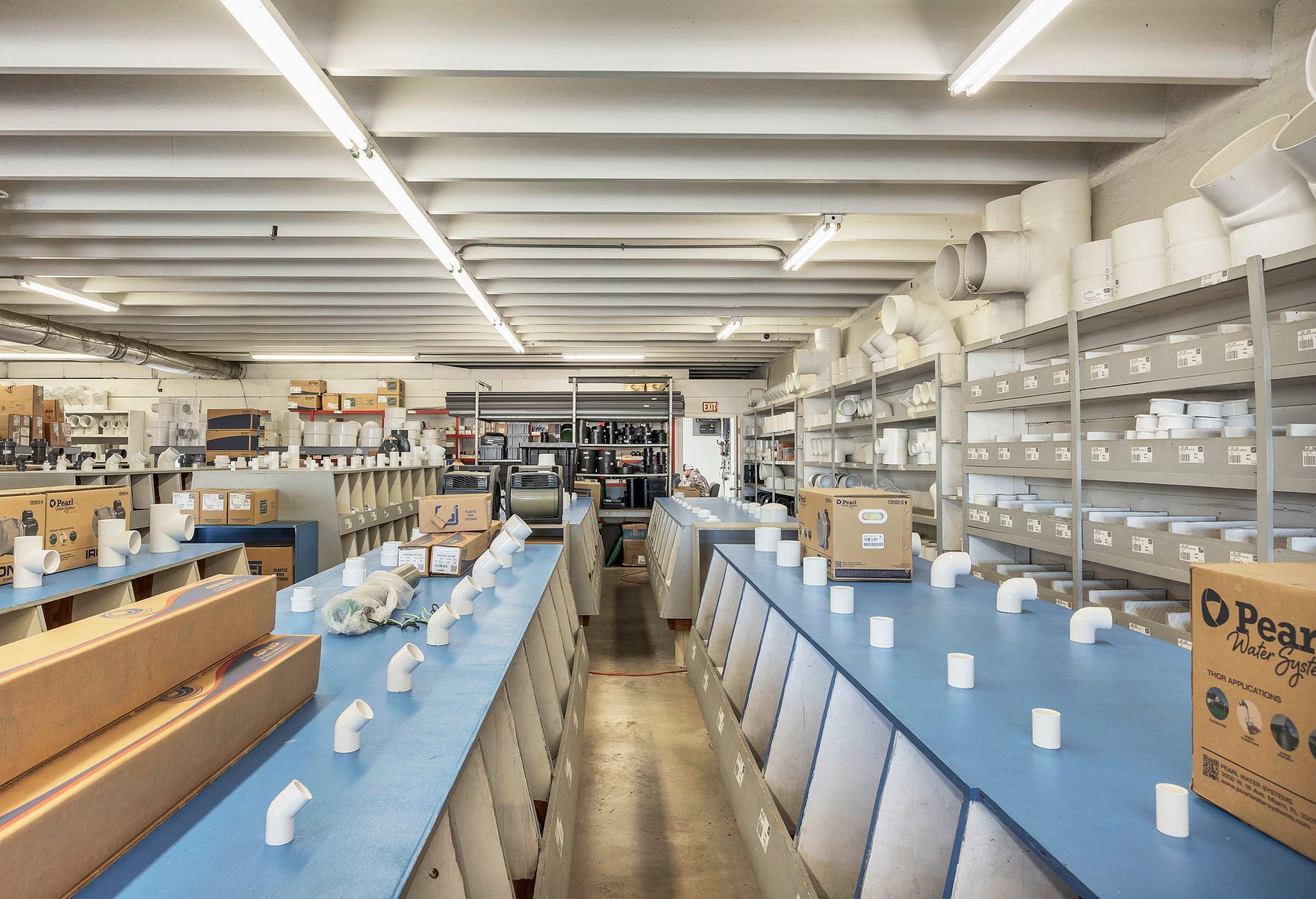 Plumbing supply store with pipes and fittings.