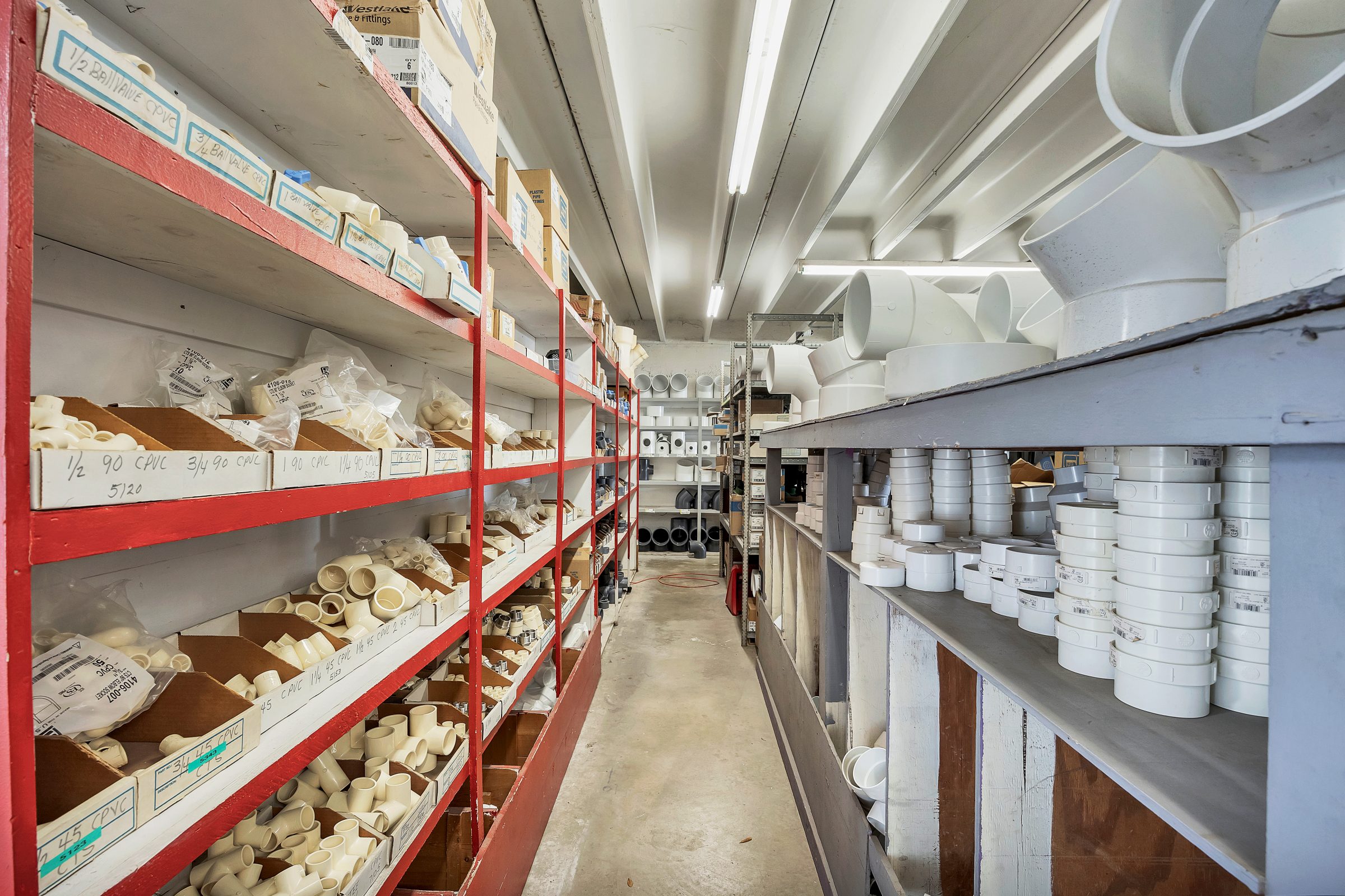 Warehouse shelves with plumbing pipe fittings