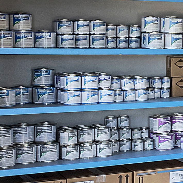 Shelves stocked with various paint cans.