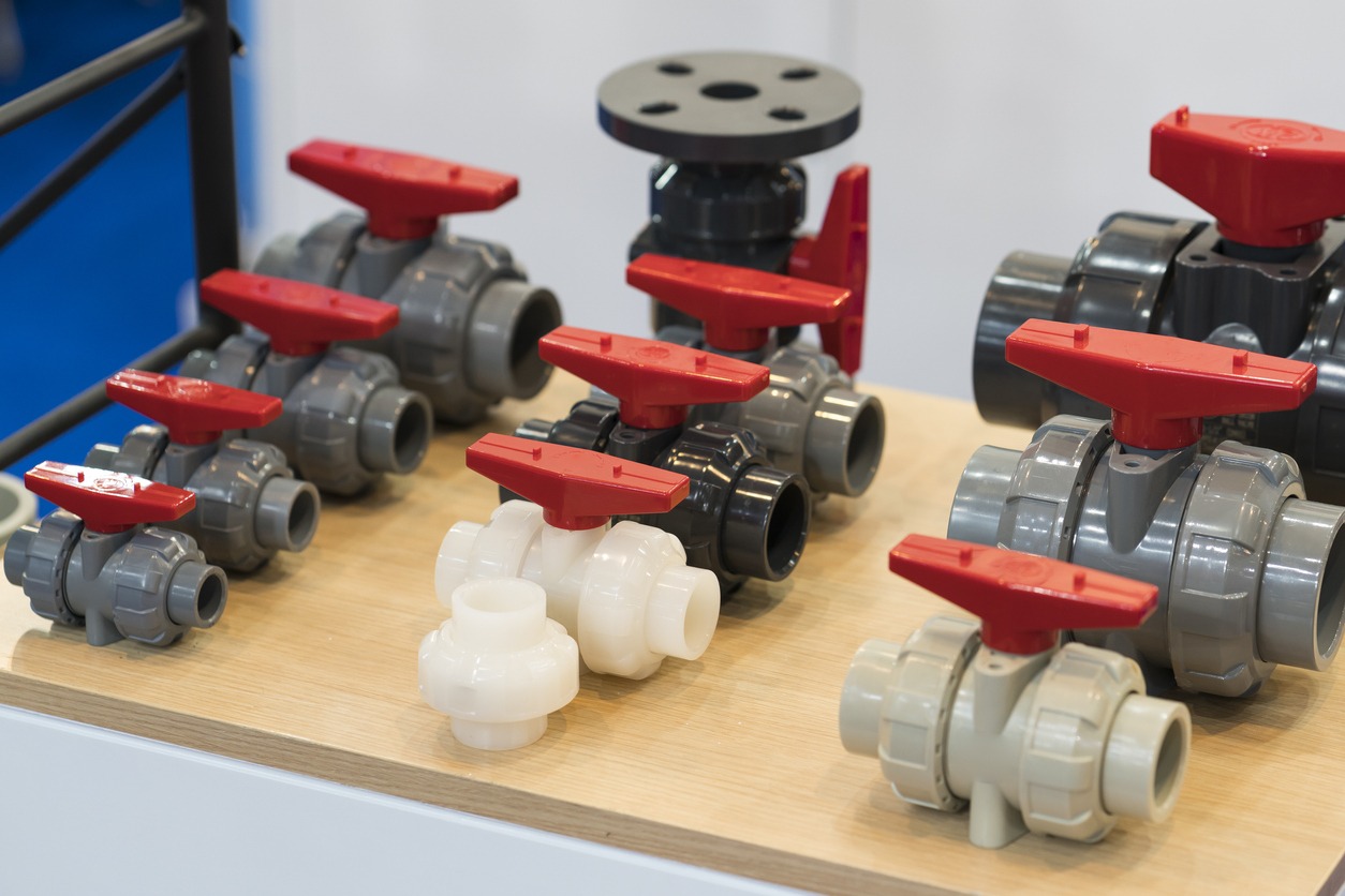 Plastic ball valves on display table with handles.