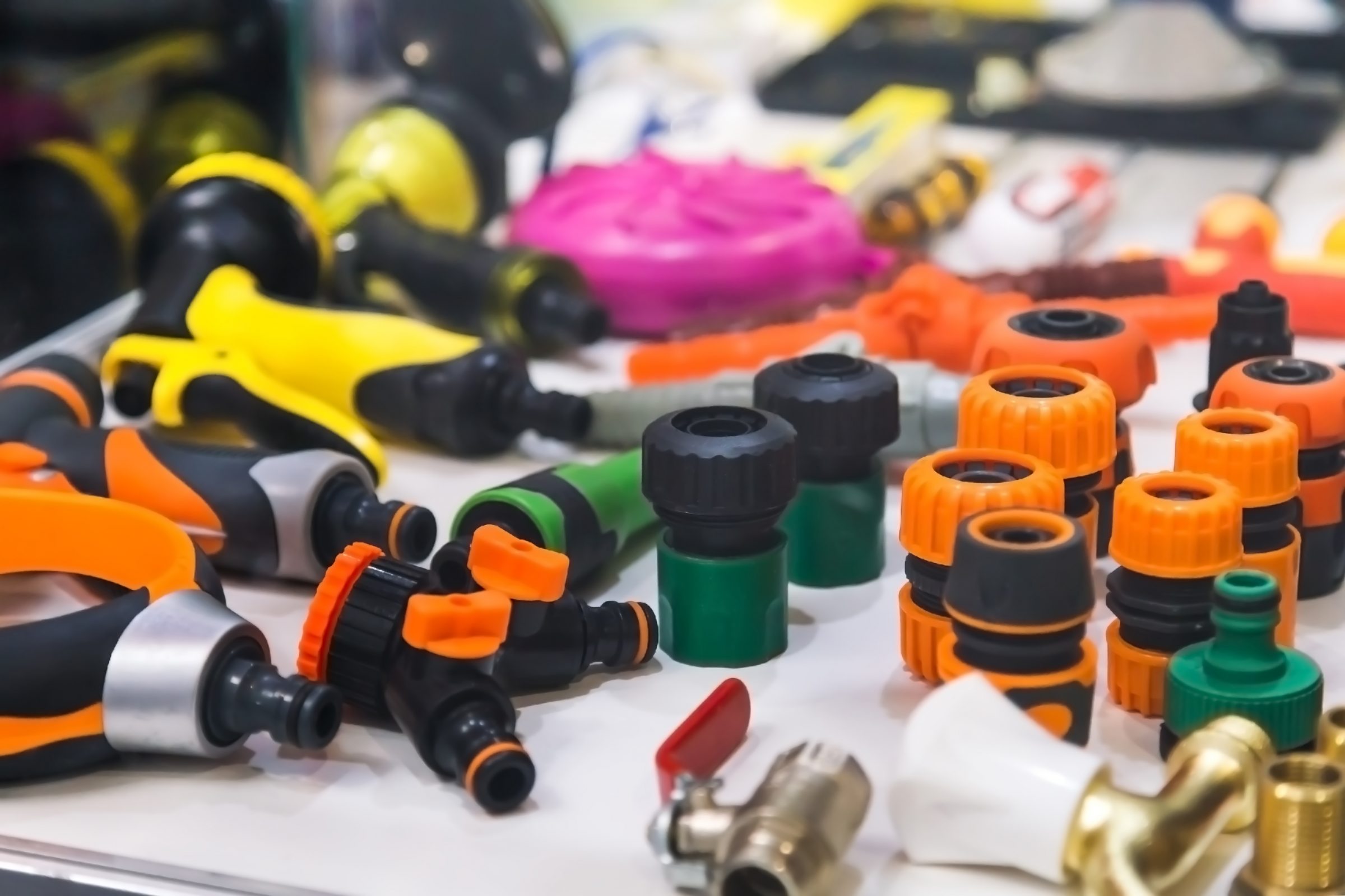 Various colorful garden hose connectors on display.