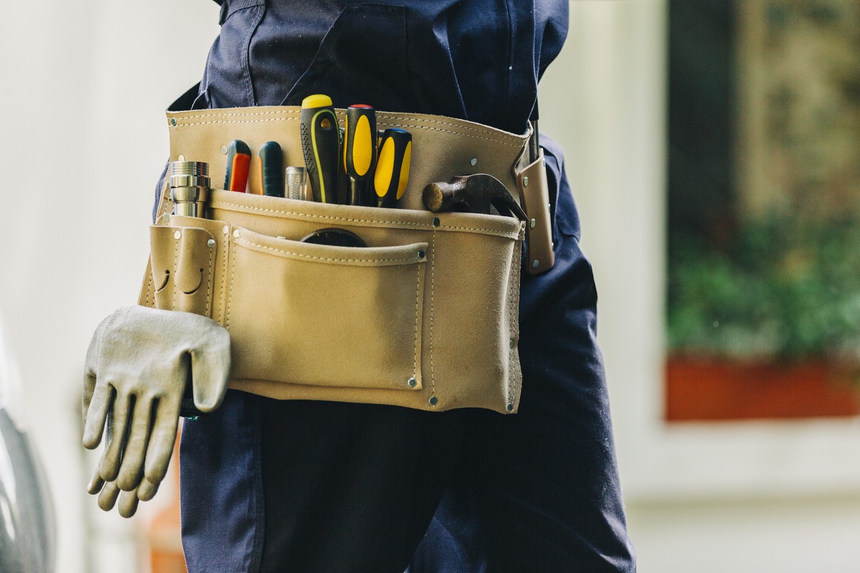 Worker with tool belt and gloves